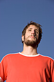 Portrait of a young soccer player, looking frustrated