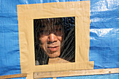 Homeless looking through the window of his living box in Tokyo, Homeless community on the banks of the Sumida River, Sumida River, Tokyo, Japan