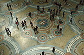 People in Galleria Vittorio Emanuele II, floor mosaic, Milan, Italy