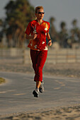 Woman jogging, running along Venice Beach, California, USA