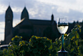 Wine glass in front of abbey St. Hildegard, Rheingau, Hesse, Germany, Europe