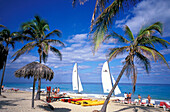 People and sailing boat on the beach, Playas del Este, Cuba, Caribbean, America