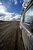 Car on road in lonesome landscape, Rio Mayo, Argentina, South America, America