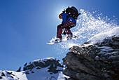 Snowboarder in action, Performing a jump, Hochfuegen, Zillertal, Tyrol, Austria