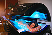 Woman on tanning-bed, Wellness
