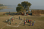 Football seen from U Bein bridge, Fussballspiel neben der U Bein Bruecke, Amarapura, Fussballplatz am Ufer, near Mandalay