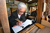Old man painting on paper, Kiyomizu Temple, Kyoto, Japan