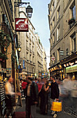 people in street scene in Saint Michel, Paris, France