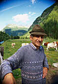 Smiling farmer standing on a pasture, Tauferer Tal, Ahrntal, Pustertal, South Tyrol, Italy