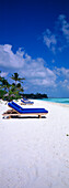 Sun lounger on the beach under blue sky, Four Seasons Resort, Kuda Hurra, Maledives, Indian Ocean