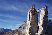 Man freeclimbing at rock formation, Dolomites, Italy