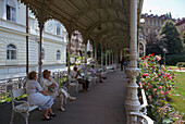 People relaxing in Spa Park, Karlovy Vary, Bohemia, Czech republic
