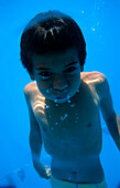 Boy, under water, Takapotu, Tuamotu Islands French Polynesia, South Pacific