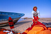 Kitesurfer prepare his equipment, Djerba Tunesia