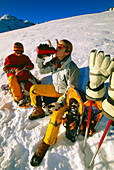 Young couple resting while snowshoeing tour, Serfaus, Tyrol, Austria