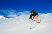 Young man snowscooting downhill, Serfaus, Tyrol, Austria