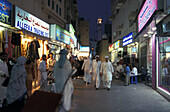 People walking through a shopping street in the evening, Souk, Dubai, United Arab Emirates