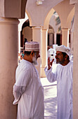 Men discussing, Souk, Nizwa, Oman