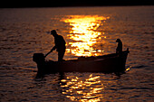 Fisherman in a boat at sunset, Marche, Italy, Europe