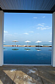Sunshades at Chedi Pool under clouded sky, The Chedi Hotel, Muscat, Oman, Middle East, Asia