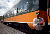 A conductor standing in front of a train, Ferrocarril Chihuahua al Pacifico, Chihuahua express, Mexico, America