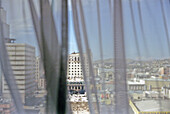 View to city through curtains, Chihuahua, Mexico