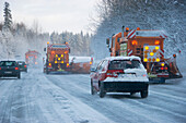Snow ploughs on highway, traffic in winter, Bavaria, Germany