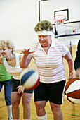 Mature People playing basketball