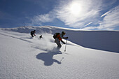 Three skier on powder snow, Nebelhorn, Oberstdorf, Bavaria