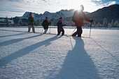 Family with two children snowshoeing in fresh powder snow, Elmau, Upper Bavaria, Germany