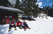 Group of telemarker sitting on slope, Zugspitze, Garmisch Partenkirchen, Germany