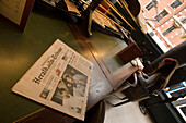 Newspaper, Woman, Cafe Americain, Leidseplein, Young woman sitting in Cafe Americain, reading and eating, newspaper lying on table in foreground, Leidseplein, Amsterdam, Holland, Netherlands