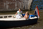 Girls, Leisure Boat, Keizersgracht , Two young women having a trip with a leisure boat on Keizersgracht, Amsterdam, Holland, Netherlands
