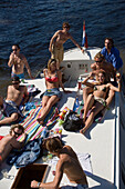 People, Leisue Boat, Amstel, Happy smiling waving young people on a leisue boat on Amstel, having a trip on a sunny day, Amsterdam, Holland, Netherlands