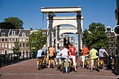 Cyclists, Magere Brug, Group of cyclists on Magere Brug Skinny Bridge, over Amstel, rear view, Amsterdam, Holland, Netherlands