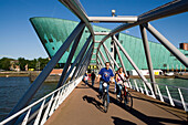 NEMO Museum, Bridge, Cyclists, Cyclists on bridge, leaving NEMO Museum, Amsterdam, Holland, Netherlands