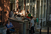 People, Provisional Open Air Restaurant, Jordaan, People sitting in a provisional open air restaurant on an extraordinary hot day, Lindengracht, Jordaan, Amsterdam, Holland, Netherlands. This special license is valid on days with over 30 degrees Celsius