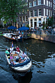 People, Boats, Cafe 't Smalle, Egelantiersgracht, Jordaan, People in leisure boat passing Cafe 't Smalle, Egelantiersgracht, Jordaan, Amsterdam, Holland, Netherlands