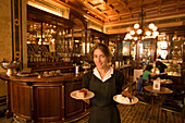 Waitress serving fancy cakes, Cafe Demel, Vienna, Austria
