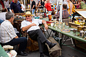 Two men in conversation at Saturday Fleamarket, Naschmarkt, Vienna, Austria