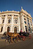 Fiaker with tourists passing the Burgtheater, Vienna, Austria