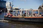 Harbour tour with a barge, People having a harbour tour with a barge at harbour, Hamburg, Germany
