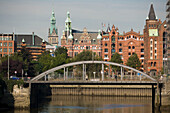 Speicherstadt and guildhall, View over a bridge to Speicherstadt and the guildhall in the background, Hamburg, Germany