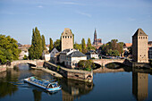 Les Ponts Couverts, Excursion boat on the river Ill passing the covered bridges Les Ponts Couverts, , Strasbourg, Alsace, France