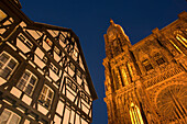 View to a timbered house and Our Lady's Cathedral, View to a timbered house and the west facade with spire of Our Lady's Cathedral Cathedrale Notre-Dame, in the evening, Rue Merciere, Strasbourg, Alsace, France