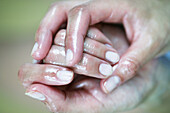 Hands of a woman, greased with oil