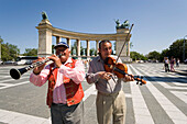 Two men making music at Heroes' Square, Two men making music at Heroes' Square near Millenary Monument, Pest, Budapest, Hungary