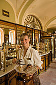 Waitress serving cake in Cafe Gerbeaud, Waitress serving fancy cake in Cafe Gerbeaud, which is specialized in hungarian cakes, Pest, Budapest, Hungary