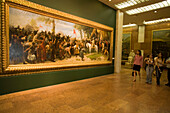 People looking at painting, Visitors looking at a painting inside the Hungarian National Gallery at Royal Palace on Castle Hill, Buda, Budapest, Hungary