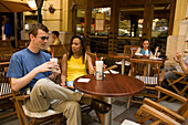 Couple drinking latte macchiato in an open-air cafe, Couple sitting in an open-air Cafe at Liszt Square and drinking latte macchiato, Pest, Budapest, Hungary